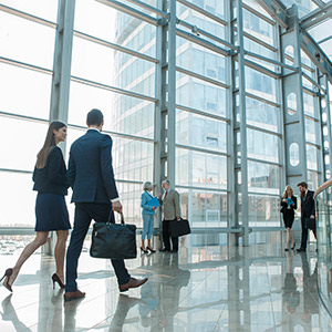 business professionals walking inside of a large bank