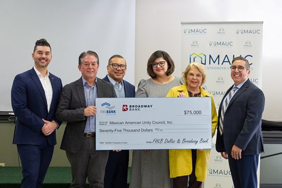 Mexican American Unity Council accepts check from Federal Home Loan Bank Dallas